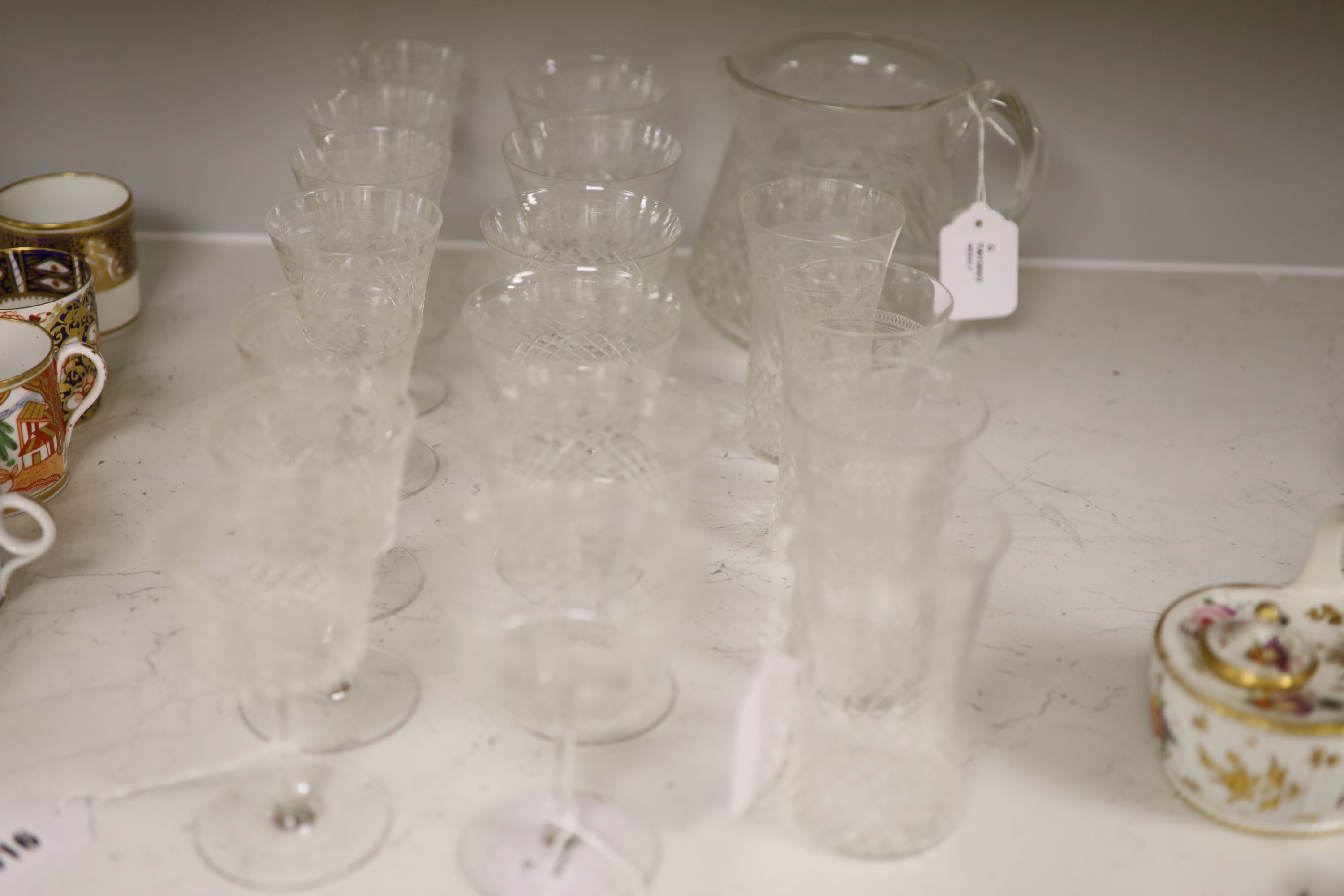 A part suite of 1930's table glass, comprising a water jug, four tumblers, six red wines and seven white wine glasses,